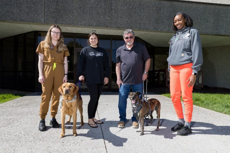 (From left) Alexandra Cleversley, Delaney Groves, Dale Stephens, and Melanie Gevedon at the Veterinary Teaching Hospital with their pets, Indie and Arya