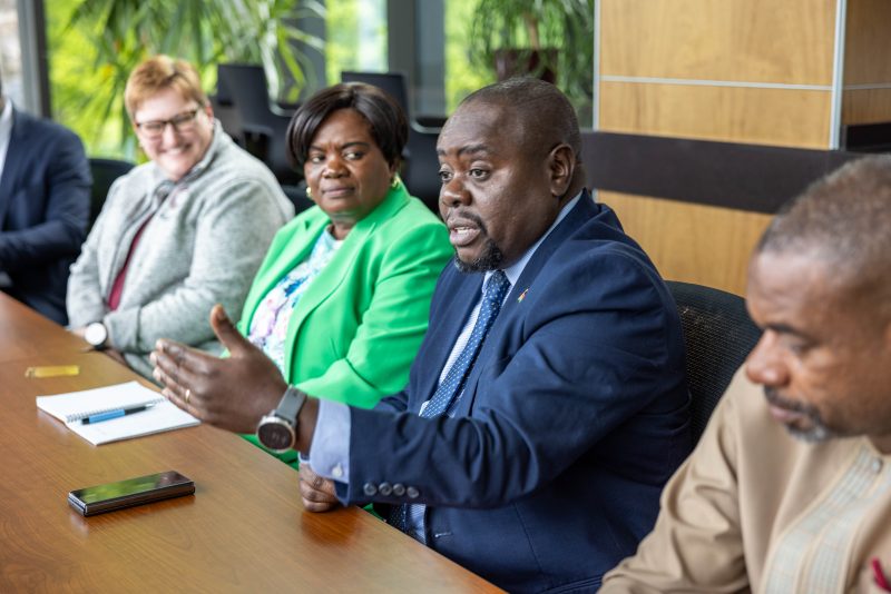 Members of MUST delegation sitting at a conference room table